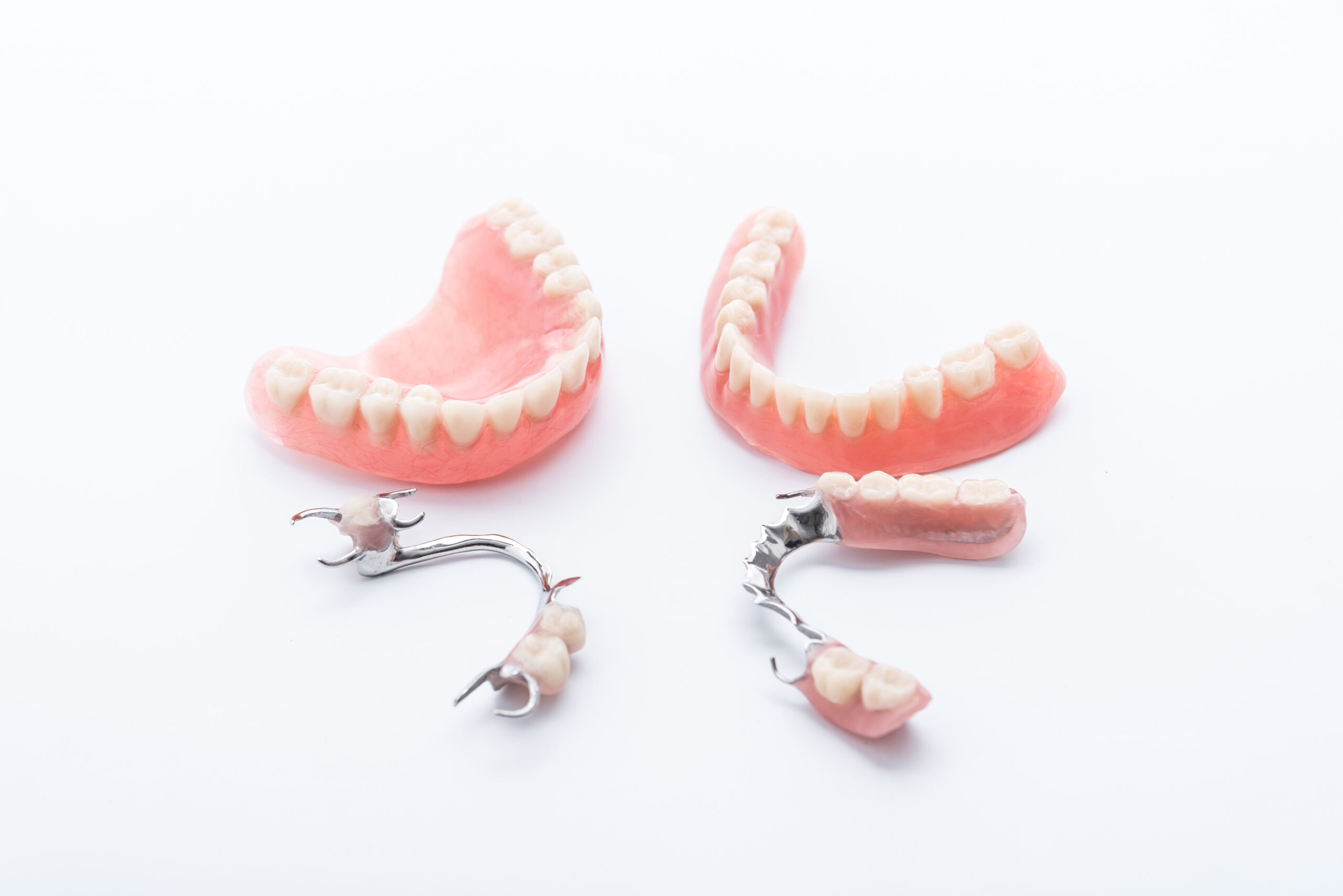Woman putting an invisalign clear aligner into her mouth